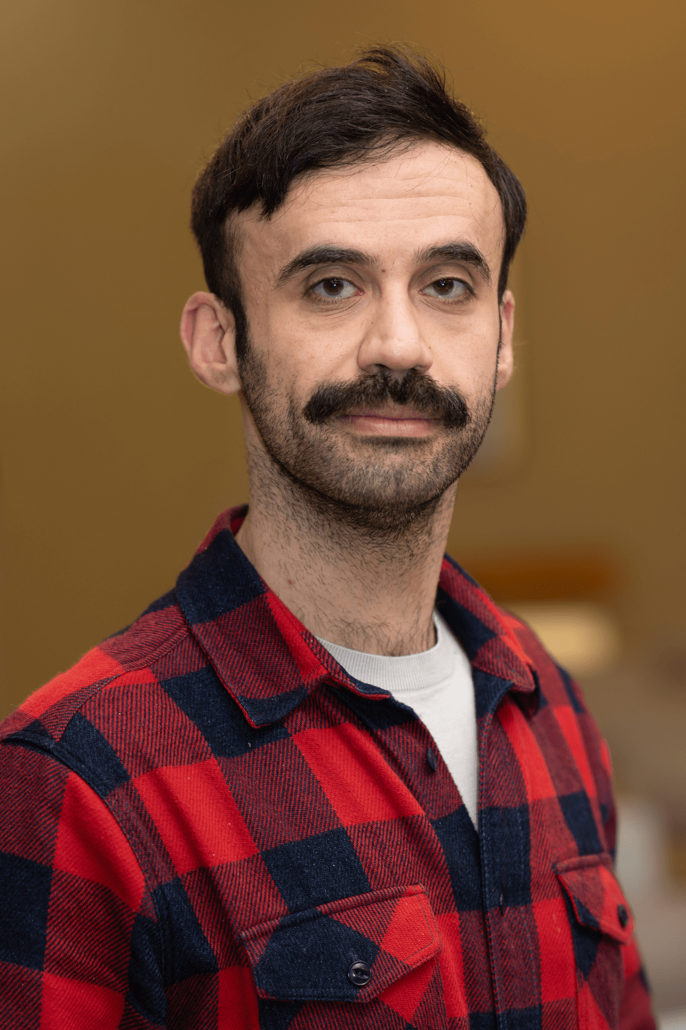 Amir Rizwan: Man with beard and glasses.